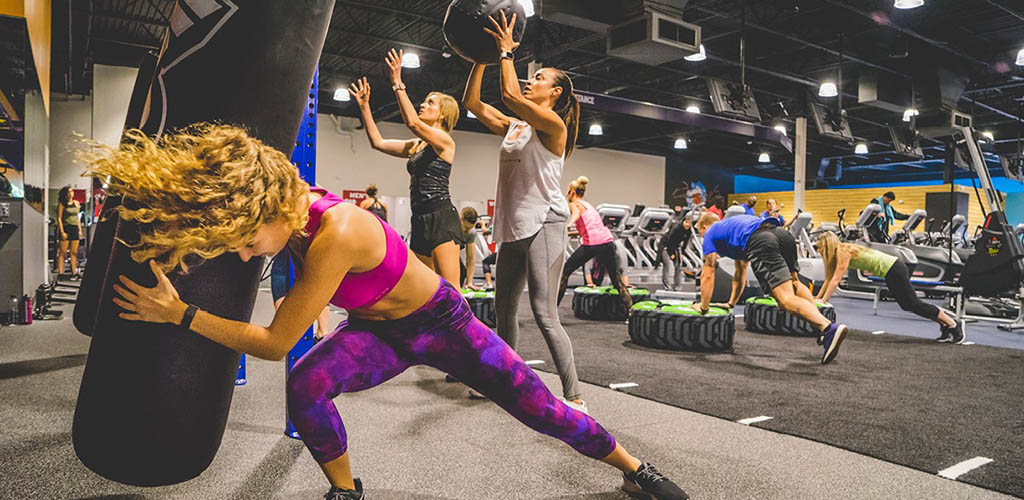 Fit women in an intense workout at Crunch Fitness