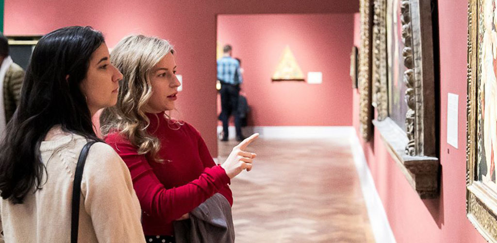 Women admiring an antique art piece at the San Diego Museum of Art