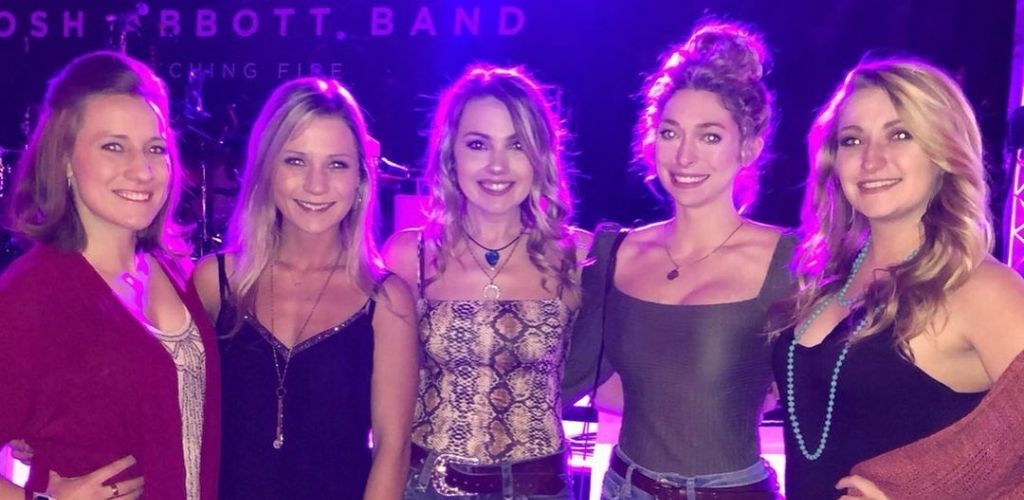 Hot Indianapolis cougars posing for a photo after a concert at 8 Seconds Salon