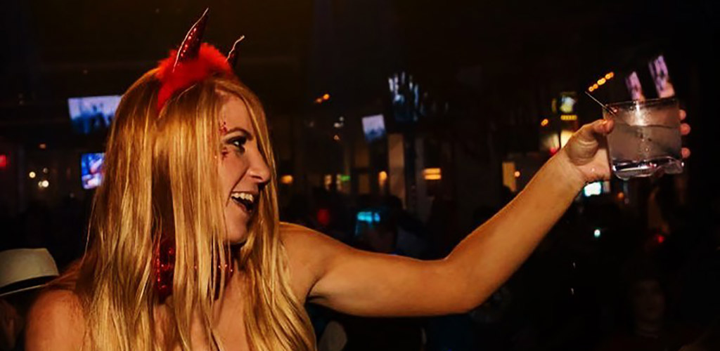 A woman in a sexy Halloween costume at Whisky River