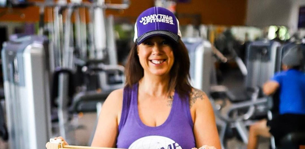 A mature woman before a workout at Anytime Fitness