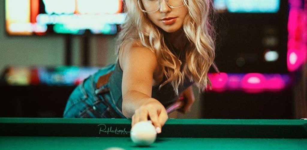 A beautiful mature woman playing pool at Rialto Pool Room
