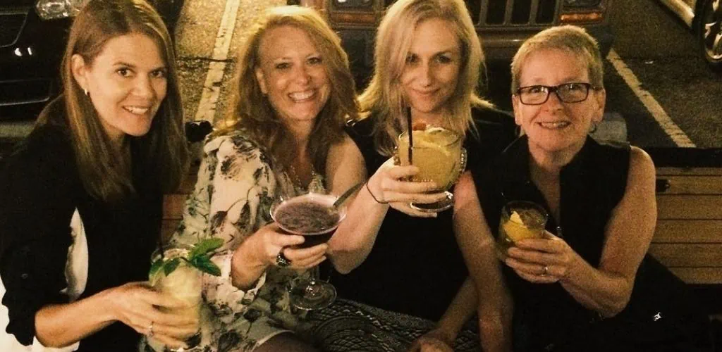Indianapolis MILFs toasting cocktails outside The Bull & Biscuit Bar