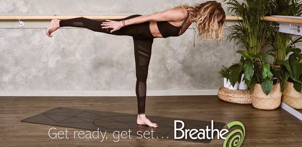 A woman in a yoga pose at Breathe Yoga and Massage