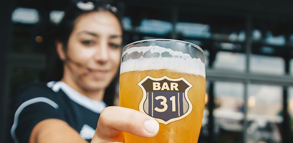 A beautiful woman holding a beer from Bar 31