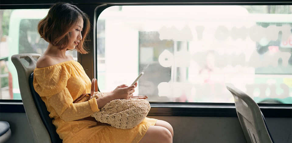 Korean MILF looking at her phone on a train