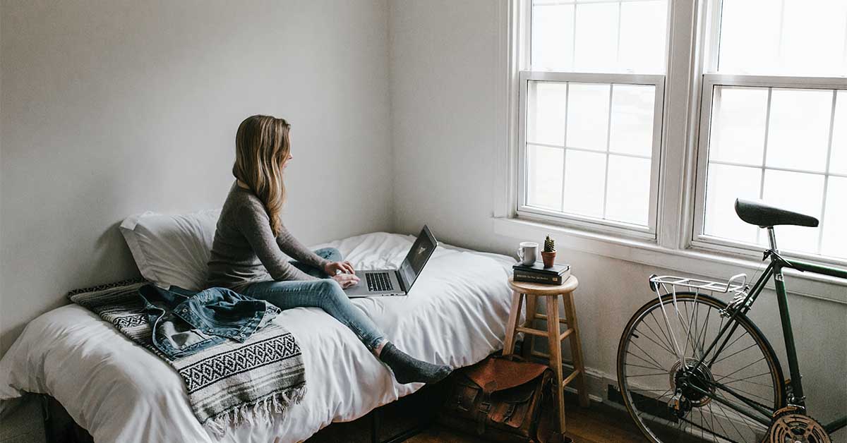 Woman in her room using online dating sites