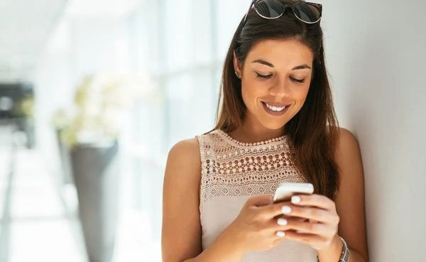 A woman looking at a text after hooking up