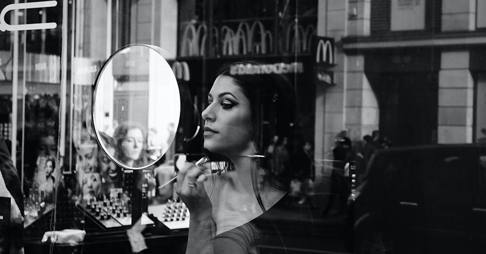 A glamorous woman applying makeup