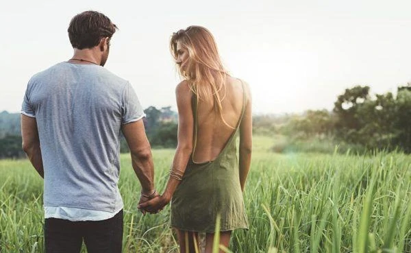 Man walking with a woman and winning her back after hurting her