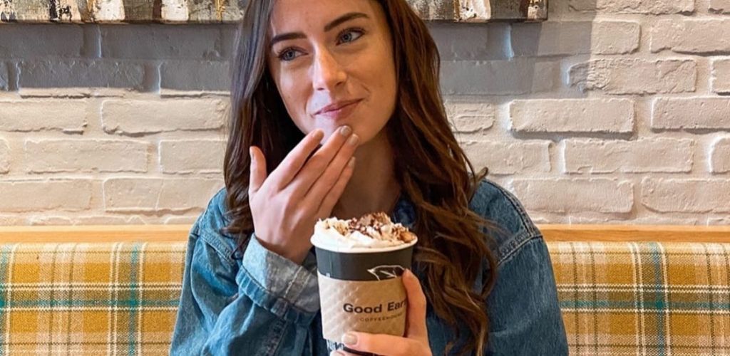 A cute Edmonton single drinking Caramel Latte at Good Earth Coffeehouse
