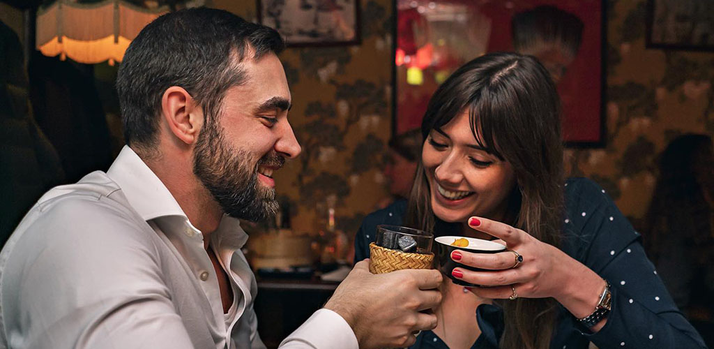 A couple drinking on a date at Opium hookup bar in London