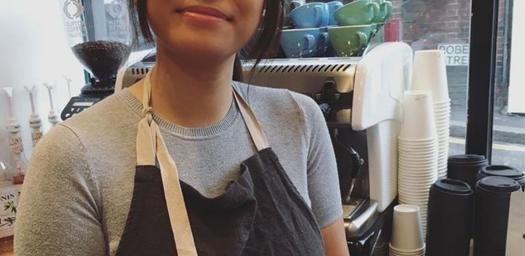 A cute barista serving coffee at Crushed Beans in Croydon