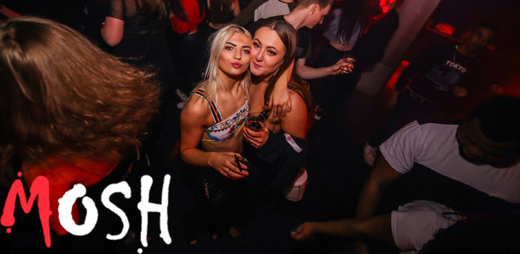 Two attractive women with drinks at Mosh