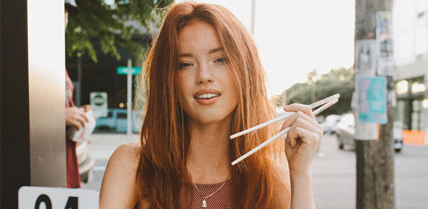 Attractive woman holding chopsticks on a date