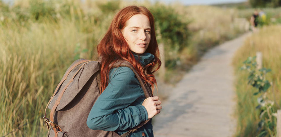 A pretty redhead girl on a hike