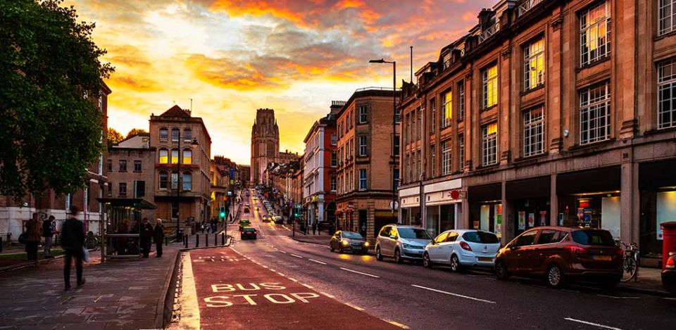 Famous street in the center of Bristol, UK in the evening during the colorful sunset