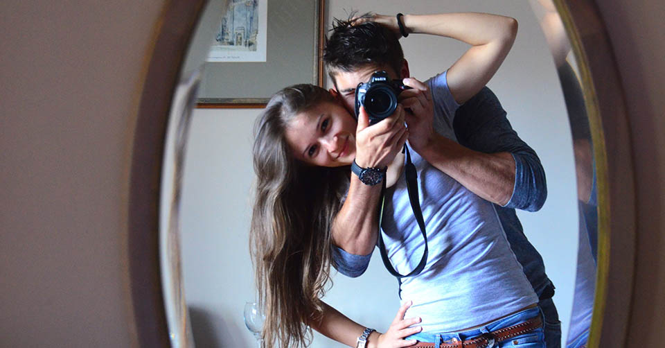 Couple taking a photo in the mirror
