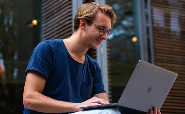 An INFJ man typing on his laptop