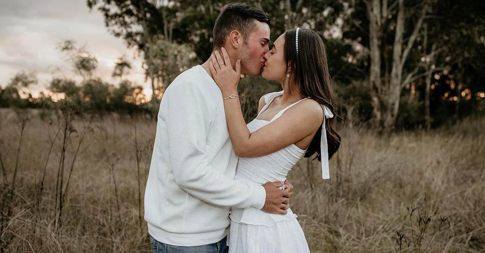 A couple kissing in a park