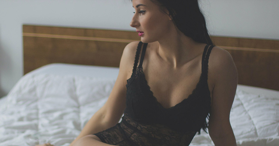 A woman in black lingerie in bed