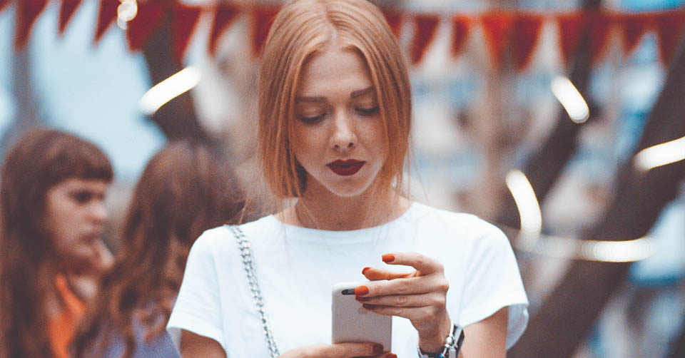 A woman texting during a festival