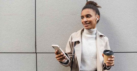 Professional woman with coffee using a Rochester dating app