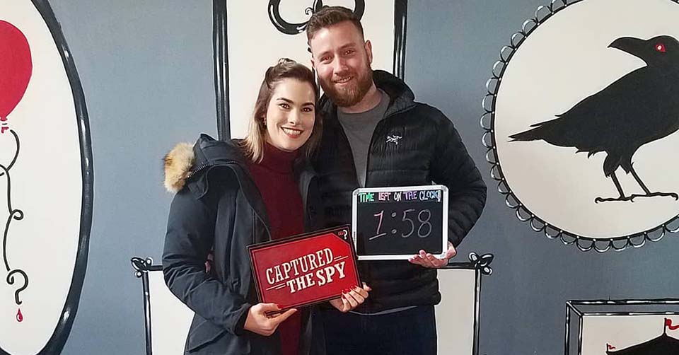 A couple successfully completing a puzzle at Charm City Clue Room Baltimore