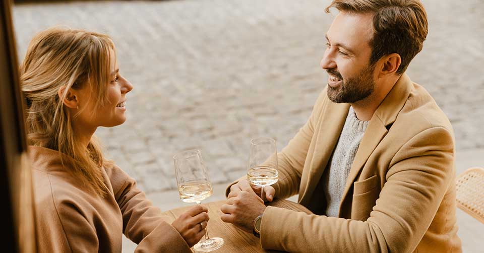A couple drinking white wine while dating in Louisville