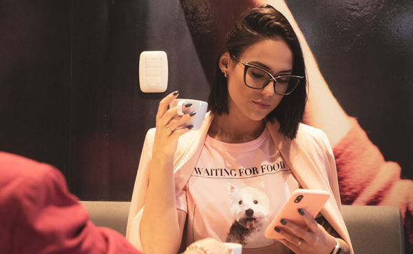 A woman with glasses using a Victoria dating app