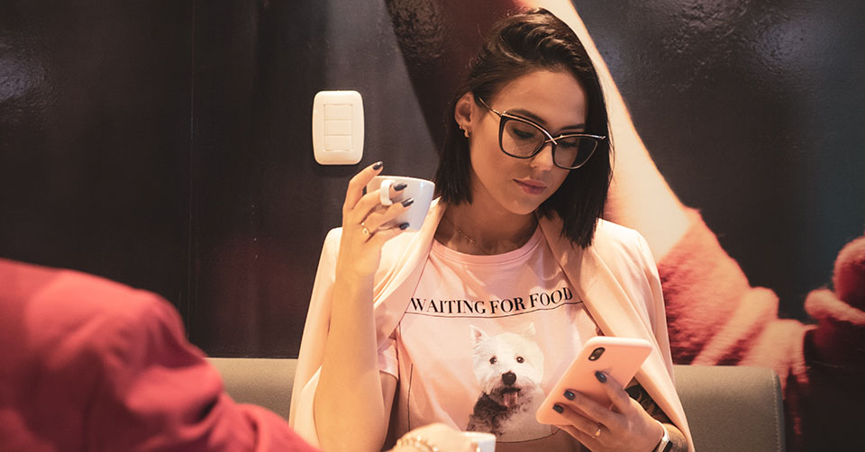 A woman with glasses using a Victoria dating app