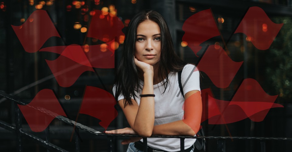 A woman surrounded by red flags