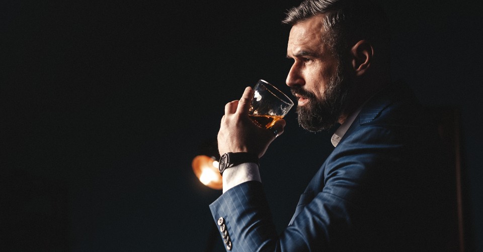 A classy man drinking whiskey