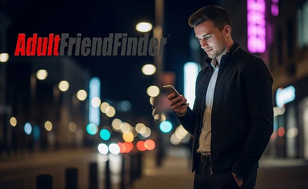 Confident man using a phone at night planning his Adult Friend Finder strategy