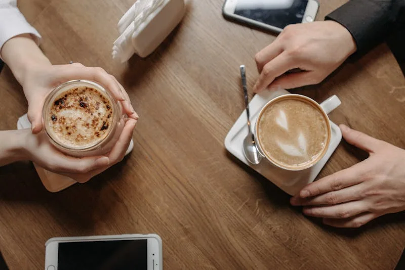 Two people meeting for a first coffee date in a small town café