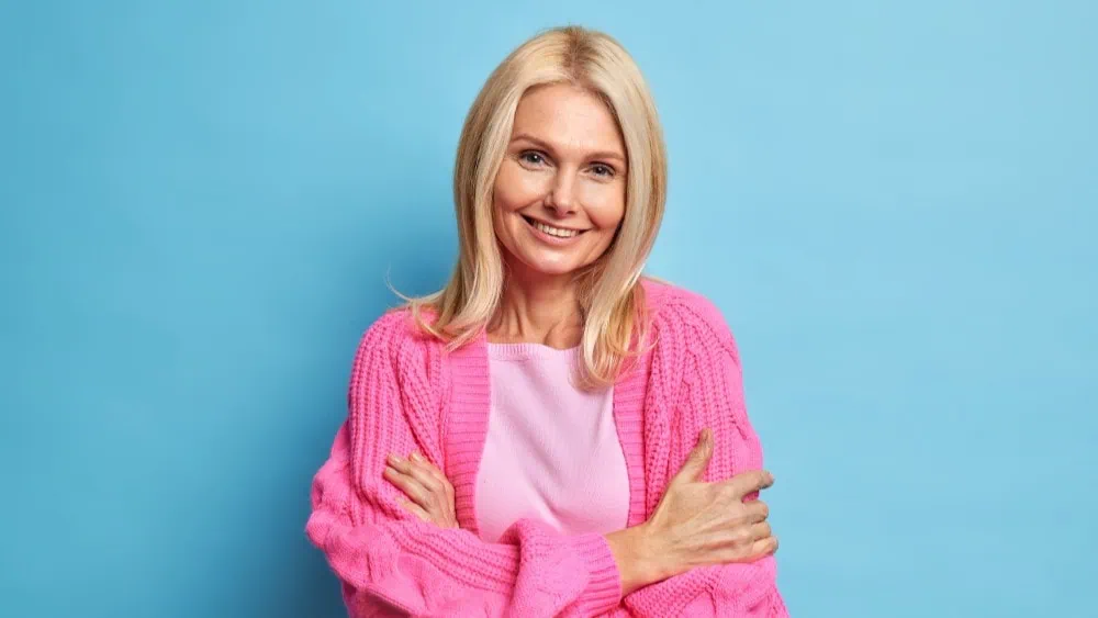 Mature woman with confident smile and laugh lines, representing the directness and appeal of older women in dating