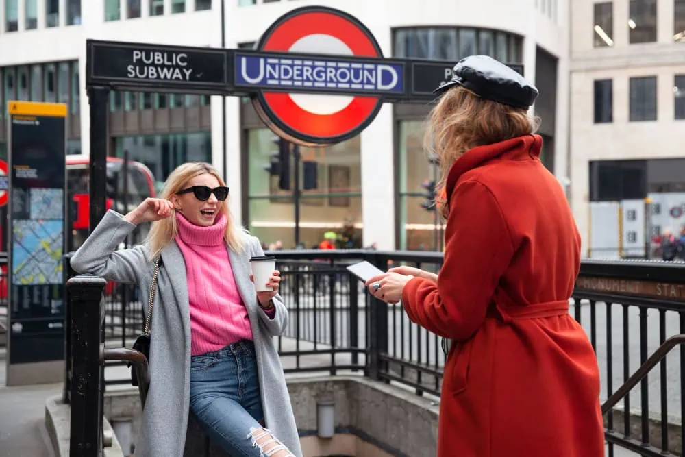 Diverse group of young adults strolling and conversing on a bustling London street, highlighting the multicultural and relaxed casual dating culture in the UK capital.
