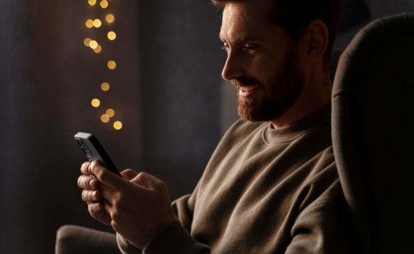 Man staring at phone, meanining navigating on Together2Night