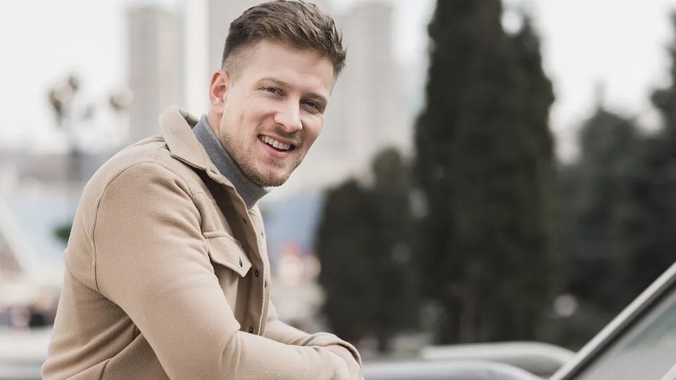 Confident smiling man outdoors in natural light, representing success on casual dating apps like Adult Friend Finder